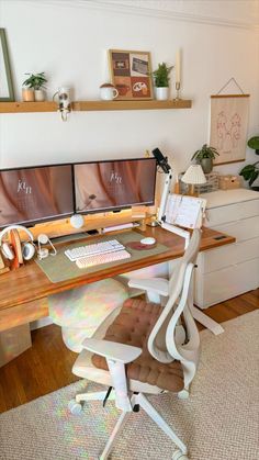 a computer desk with two monitors and a keyboard on it in front of a window