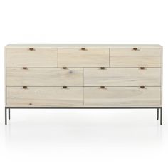 a white dresser with wooden drawers and metal legs