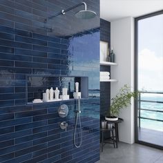 a bathroom with blue tile walls and flooring next to an open shower head, shelves on either side of the bathtub