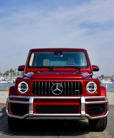 the front end of a red mercedes g - class