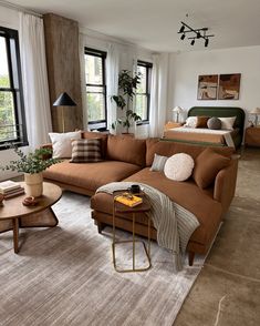 a living room filled with furniture and lots of windows