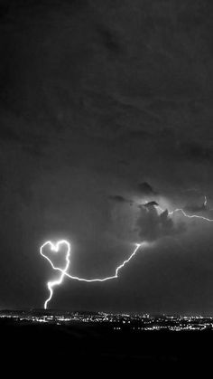 a black and white photo of lightning in the sky