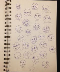 an open notebook with various faces drawn on it