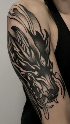 a woman with a dragon tattoo on her arm