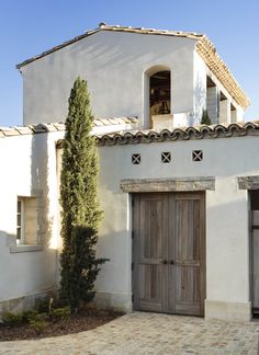 a white house with two wooden doors and windows