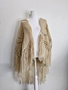 Fluffy, open knit Shawl with large spiral design and Fringe around entire bottom. Hand knit to perfection. Yarn is soft and fluffy, Fringe is perfect. No itchiness. Perfect shoulder wrap from the 1970s. Bohemian Open Knit Crochet Top One Size, One Size Bohemian Open Knit Crochet Top, Bohemian One-size Open Knit Crochet Top, Bohemian One Size Open Knit Crochet Top, Bohemian Knitted Crochet Top For Winter, Bohemian Crochet Top In Knitted Yarn, Beige Crochet Bohemian Cardigan, Beige One-size Crochet Top, One Size Beige Crochet Top