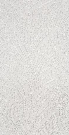 an image of a white textured wallpaper with small leaves on the top and bottom