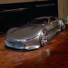 a silver mercedes sports car on display in a museum