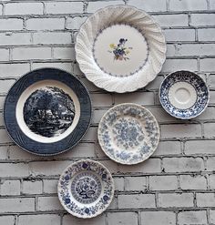 four plates are arranged on a brick wall