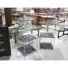 several glass tables and chairs in a room