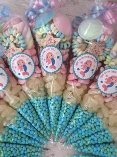 there are many candy candies in the bag on the table with blue and pink decorations