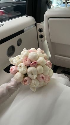 a bridal bouquet sitting in the back seat of a car