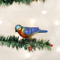 a colorful bird sitting on top of a christmas tree