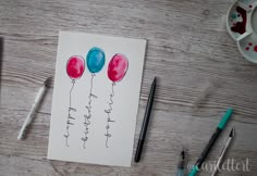 a drawing of three balloons with the words happy birthday written on them and some markers next to it