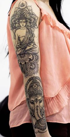 a woman's arm with tattoos on it and an image of a buddha in the middle