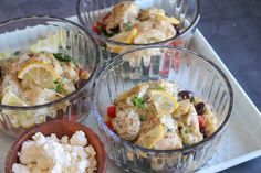 three small bowls filled with food on top of a white tray