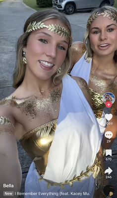 two women dressed in gold and white posing for the camera