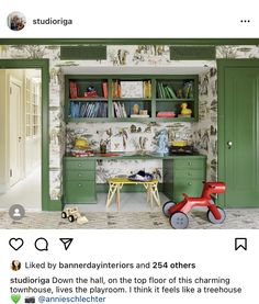 a child's playroom with green cabinets and wallpaper, including a toy horse