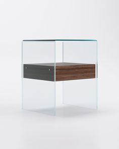 an office desk with glass and wood accents