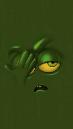 a green monster with yellow eyes looking at the camera while holding his hands to his face