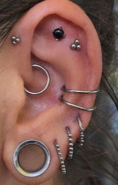 an ear with several piercings attached to it