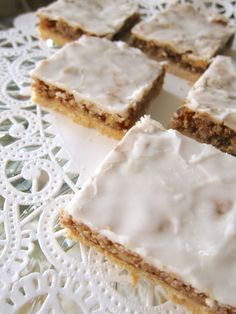 several pieces of cake sitting on top of a white doily