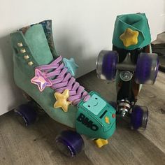 two roller skates sitting next to each other on the floor in front of a wall