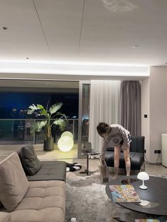 a person bending over in a living room