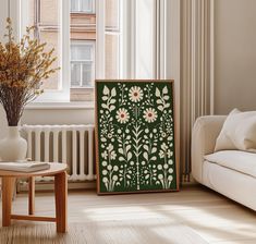 a living room filled with furniture and a painting on the wall next to a window