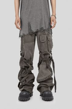 Step into a daring fusion of post-apocalyptic utility and contemporary fashion with the "Scavenger Heavyduty Multi-Pockets Striped Cargo." Crafted with an intricate blend of fabrics and deconstructed style, these wild cargo pants are more than just a clothing item - they're an audacious statement piece. Its vintage wash, rich asymmetrical design marked by multiple pockets and mesh fabric decorations, and striking straps wrapping around the garment, create an unforgettable visual appeal. Zippers Apocalyptic Fashion Mens, Dystopian Fashion Men, Ripped Fashion, Urban Wear Streetwear, Apocalyptic Clothing Men, Male Layered Outfit, Utility Clothes, Functional Streetwear Cargo Pants With Multiple Pockets, Torn Clothes