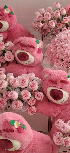 several pink teddy bears with roses on them