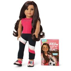 a doll with long hair and leggings next to a book