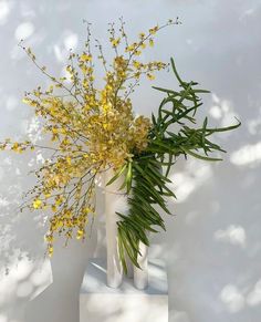 a vase with some yellow flowers in it