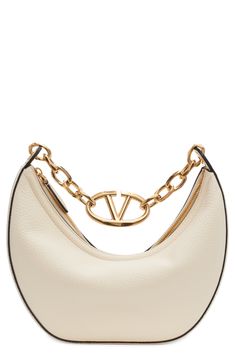 A gleaming chain centered with a VLOGO insignia spans the top of this hobo crafted from calfskin leather in a perfectly slouchy silhouette. Top zip closure Shoulder strap Leather lining Leather Made in Italy Designer Handbags White Valentino Bag, Valentino Bag, Slouchy Bag, Bag With Chain, Luxury Purses, Fancy Bags, Valentino Bags, Leather Hobo Bag, Leather Hobo