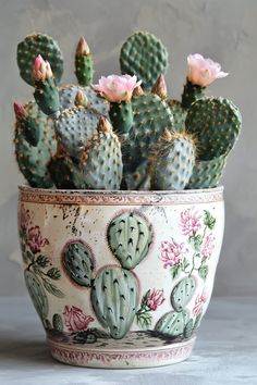 a potted cactus with pink flowers in it