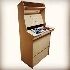 an old fashioned arcade machine is made out of cardboard