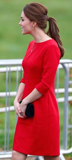 a woman in a red dress is walking