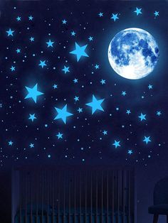 the moon and stars glow brightly in the dark night sky above a baby crib