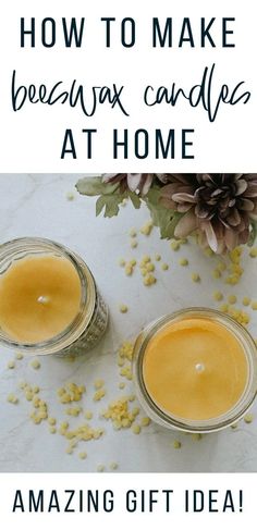 two jars filled with beeswax candles on top of a table