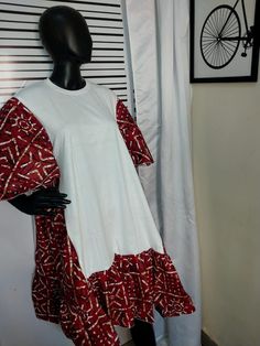 a mannequin wearing a red and white dress