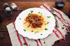 a white plate topped with rice and meat