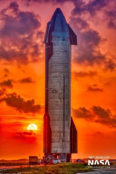 the space shuttle is on display in front of an orange sunset