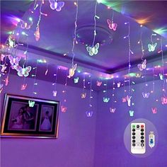 the ceiling is decorated with colorful lights and butterflies hanging from it's ceiling, along with remote controls