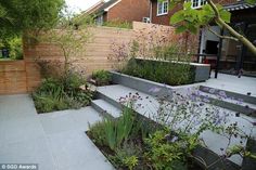 an outdoor garden with steps leading up to the house