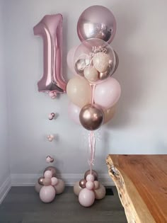 balloons and streamers in the shape of number one