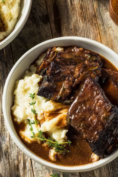 two bowls filled with meat and mashed potatoes