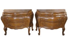 a pair of wooden dressers sitting next to each other