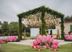 an outdoor wedding setup with pink flowers and greenery