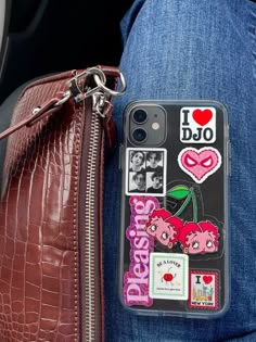 a cell phone case with stickers on it sitting in someone's back pocket