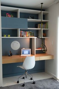 a desk with a laptop on it in front of a book shelf and bookshelf